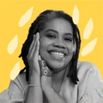 Luciana Viegas, sorrindo e apoiando o rosto nas mãos. Ela veste uma blusa clara e está em frente a um fundo amarelo com formas orgânicas decorativas.